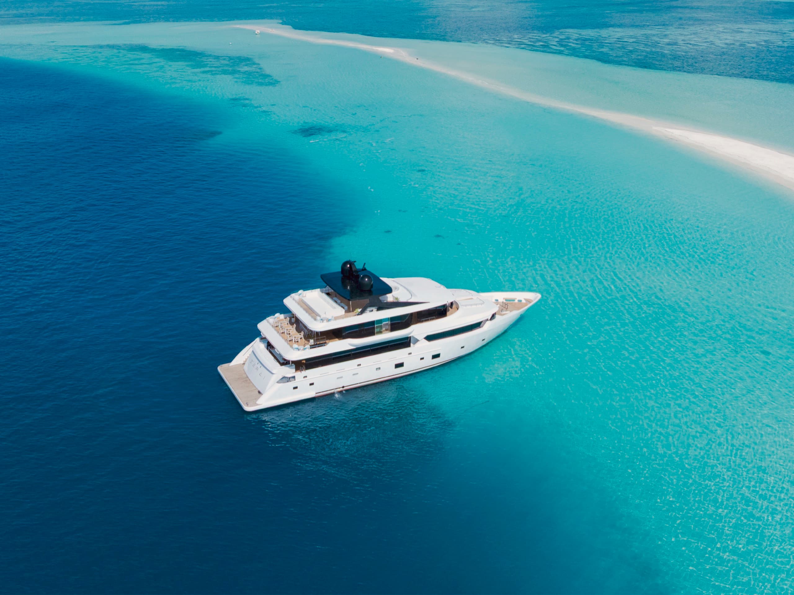 The yacht against a deep-blue channel