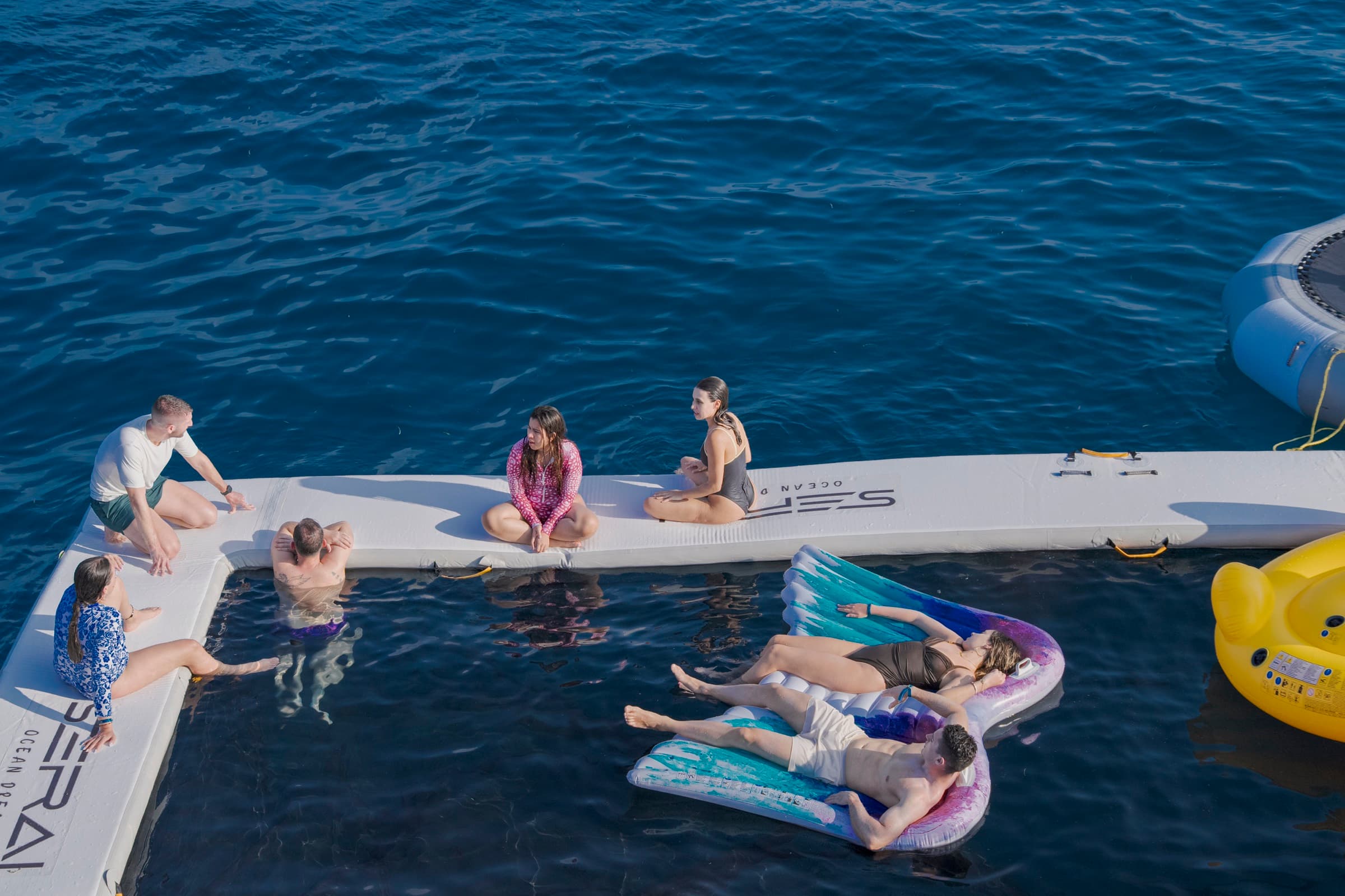 Guests enjoying water toys and activities from the SERAI Ocean Dream swim platform